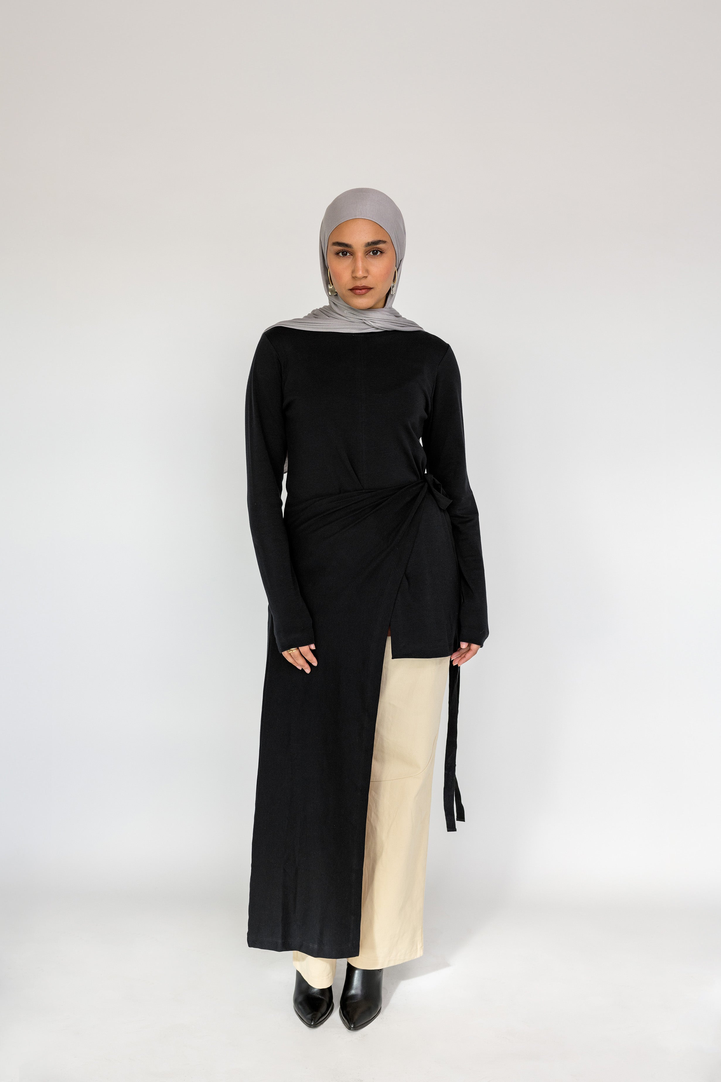 Loose-fitting top with a soft drape and subtle high-low hem for easy layering.