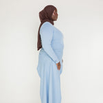 Polished casual top with a longer back, relaxed fit, and smooth cotton-blend texture