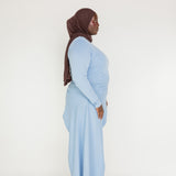 Polished casual top with a longer back, relaxed fit, and smooth cotton-blend texture
