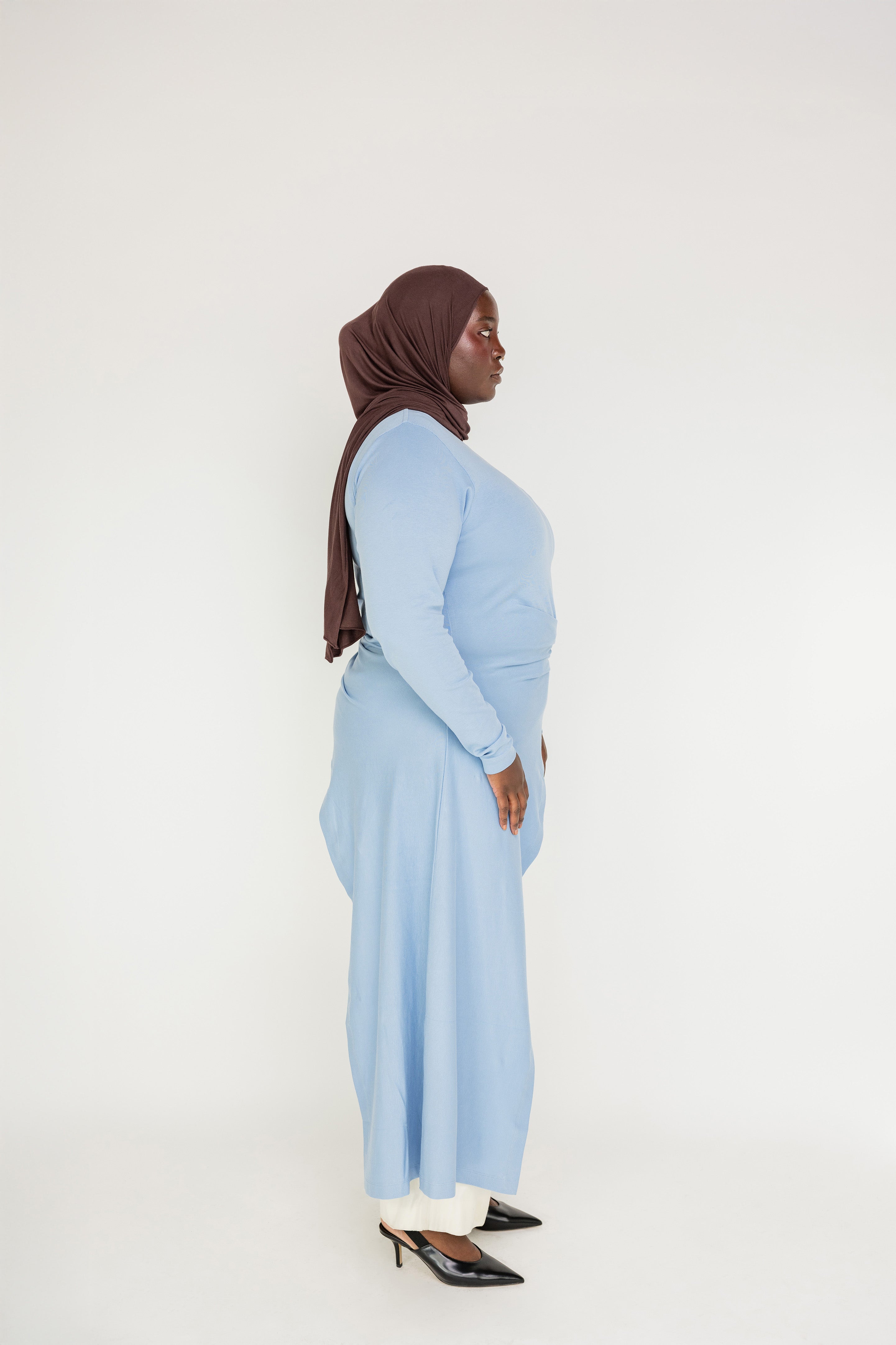Polished casual top with a longer back, relaxed fit, and smooth cotton-blend texture