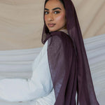 Model wearing soft modal hijab with a rich, layered tone and smooth drape.