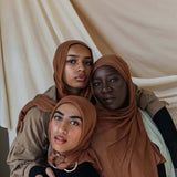Three Models wearing bamboo hijab in a balanced light brown tone with soft, cushy texture.