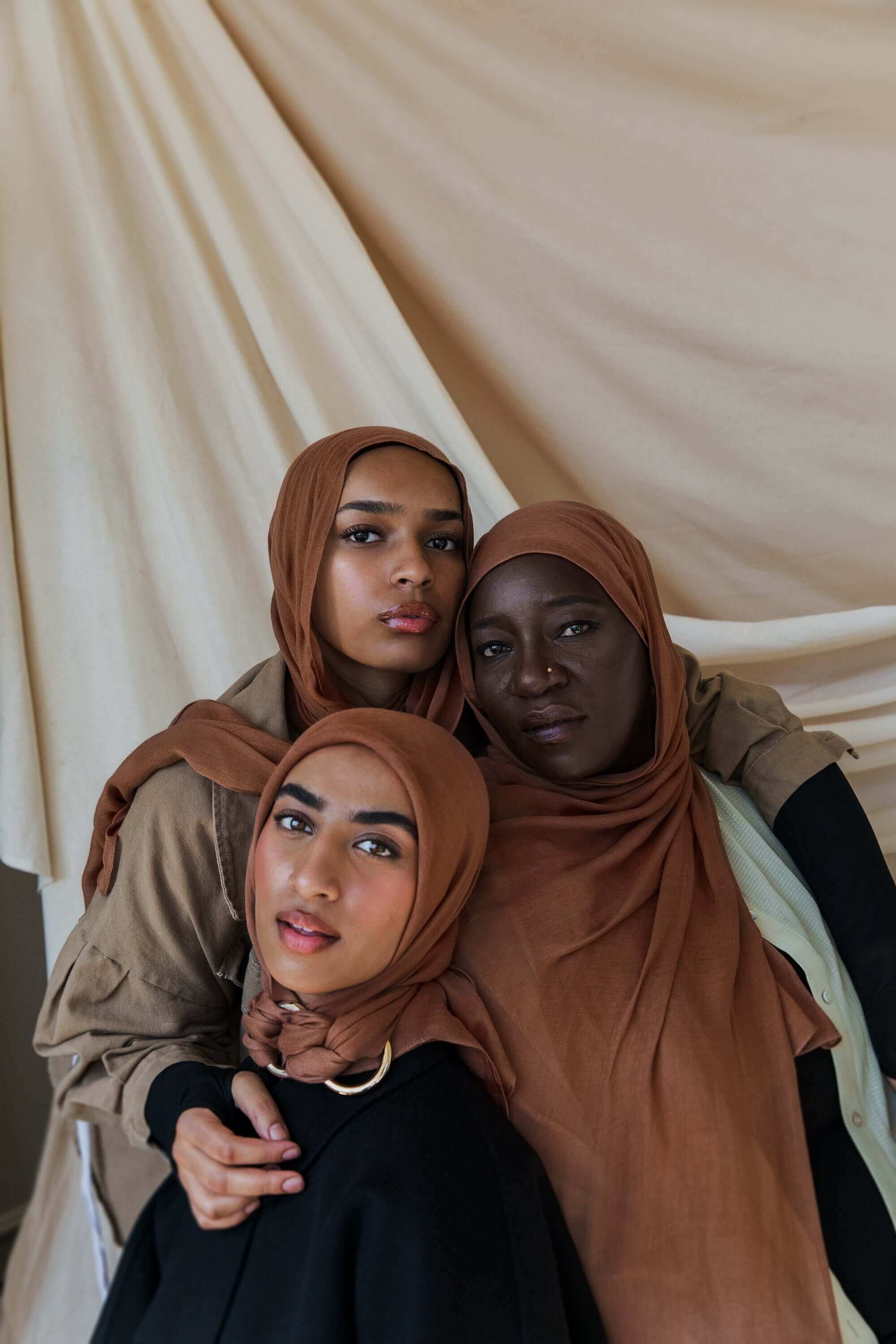 Three Models wearing bamboo hijab in a balanced light brown tone with soft, cushy texture.