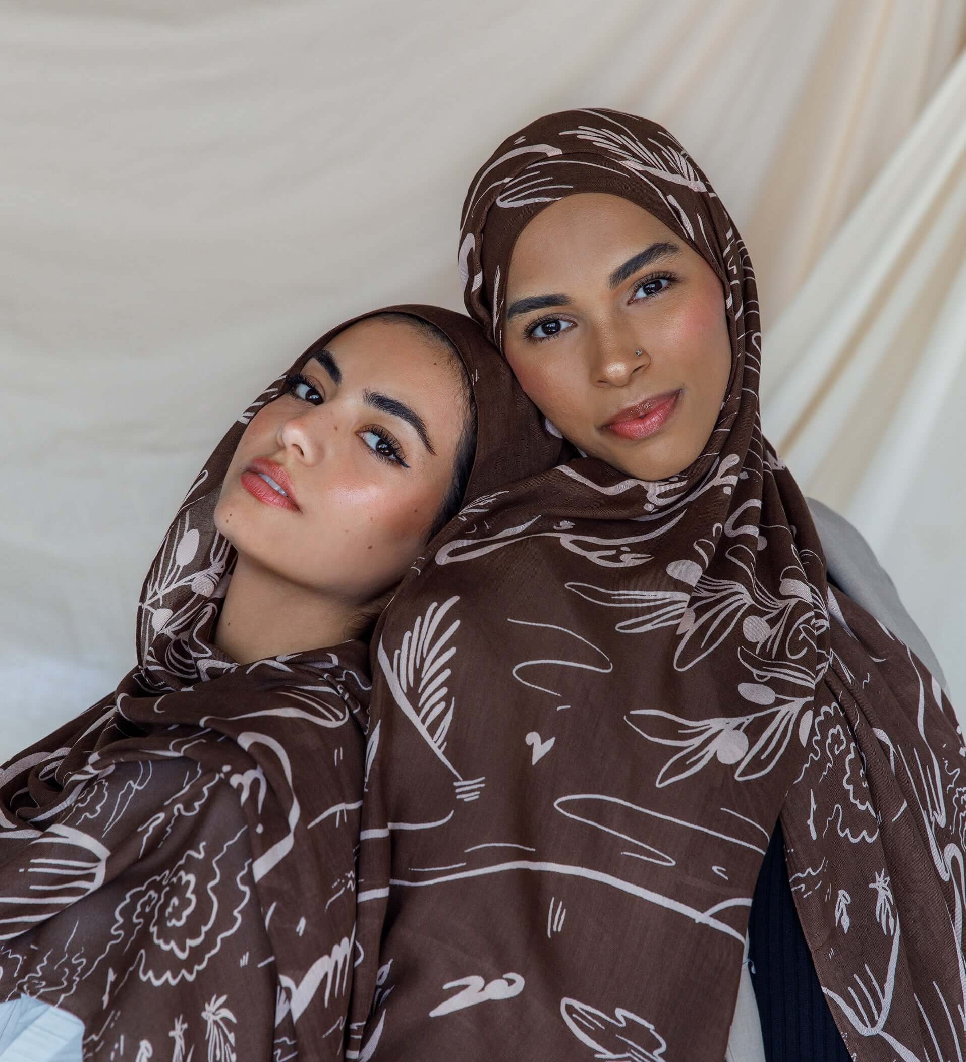 Lightweight hijab with hand-drawn Arabic lyrics expressing longing and heritage.