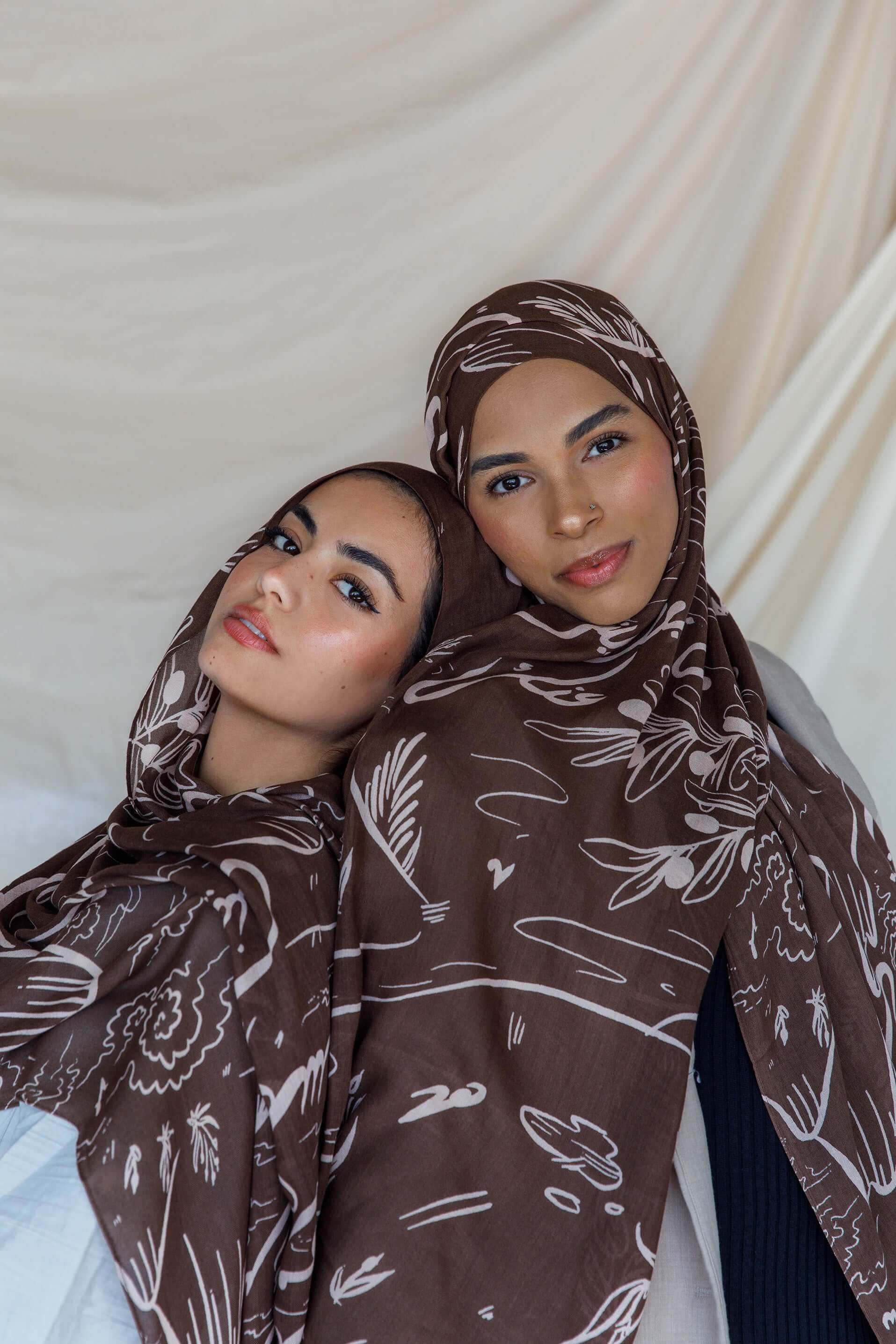 Lightweight hijab with hand-drawn Arabic lyrics expressing longing and heritage.