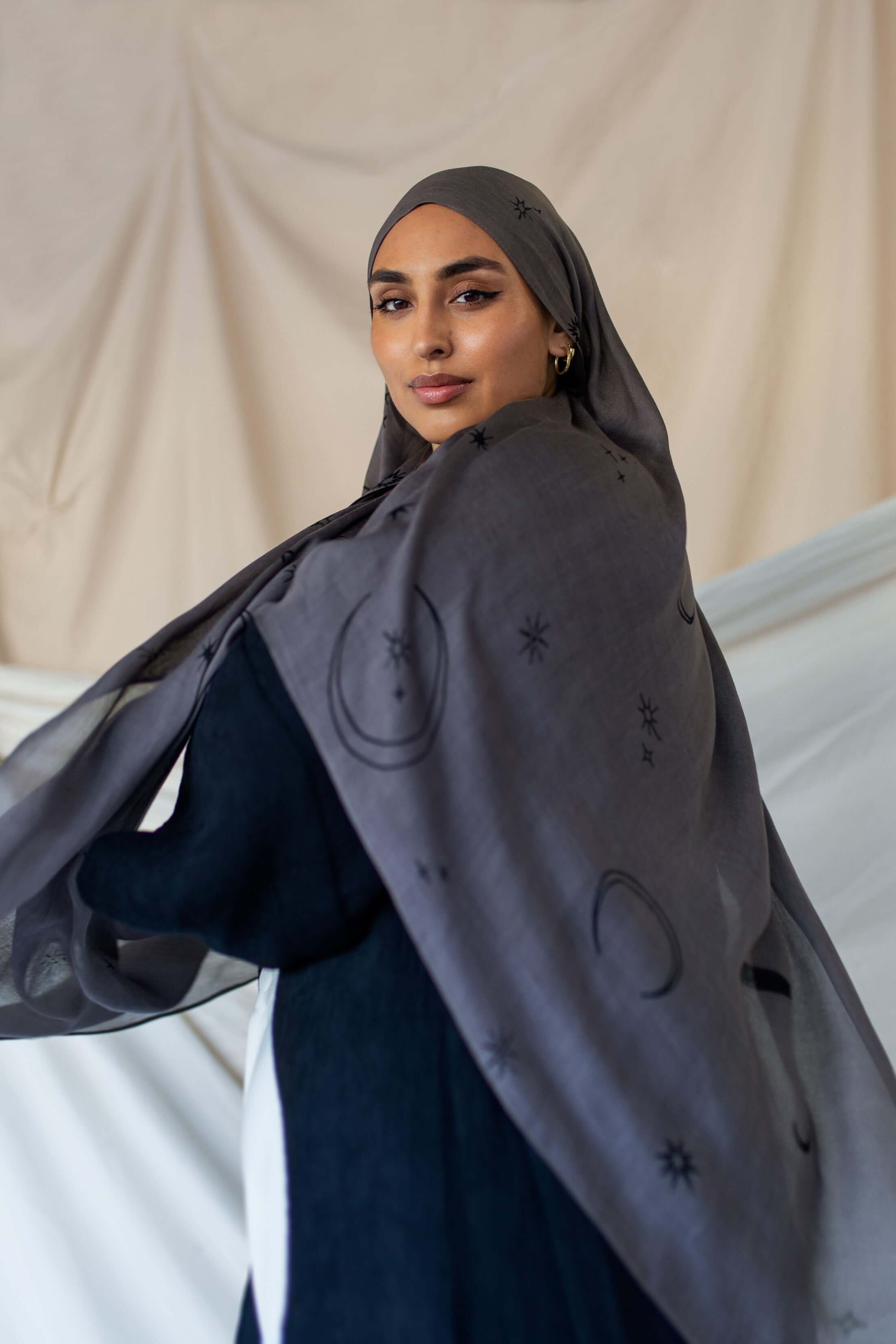 Elegant modal hijab featuring scattered moons and stars for a softly luminous look