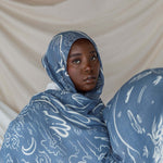 Hijab with Arabic calligraphy artwork representing cultural memory and emotional ties