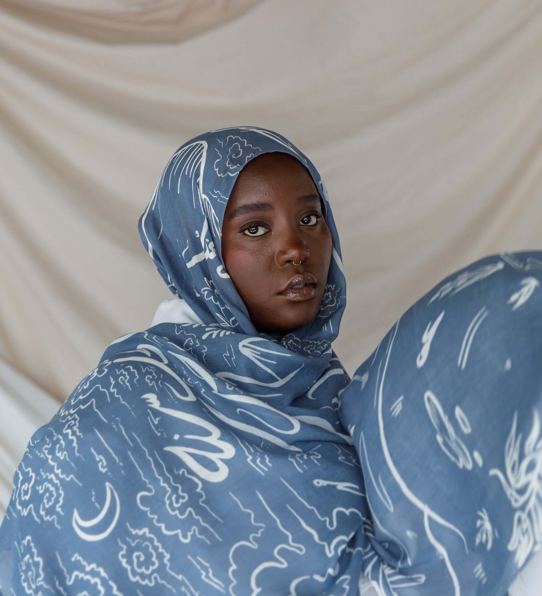 Hijab with Arabic calligraphy artwork representing cultural memory and emotional ties