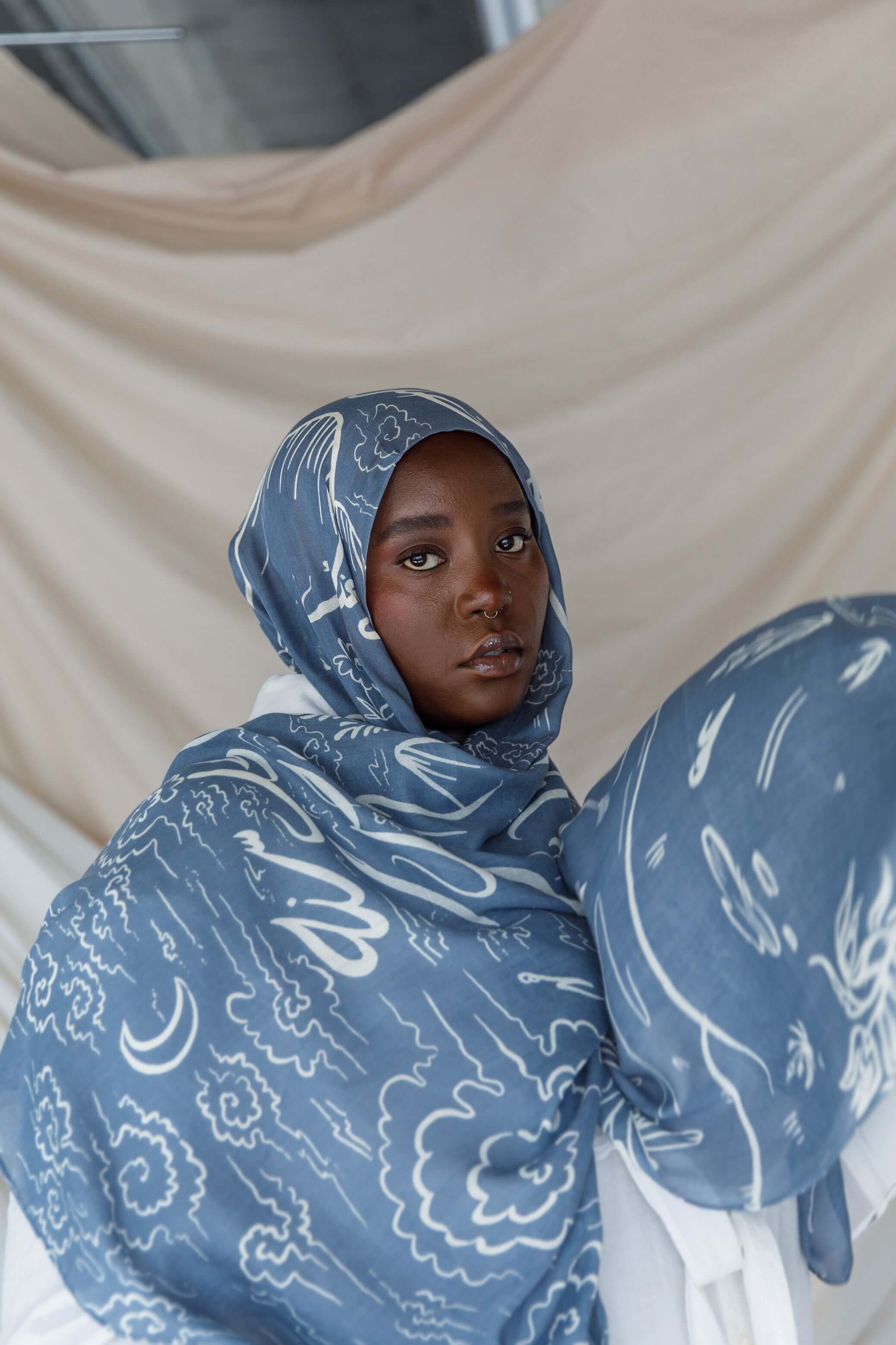 Hijab with Arabic calligraphy artwork representing cultural memory and emotional ties