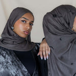 Woven modal hijab featuring crescent moon and star motifs for a celestial touch.