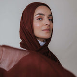 Model wearing soft, airy hijab made from 100% modal with gentle movement and artisanal dyeing.