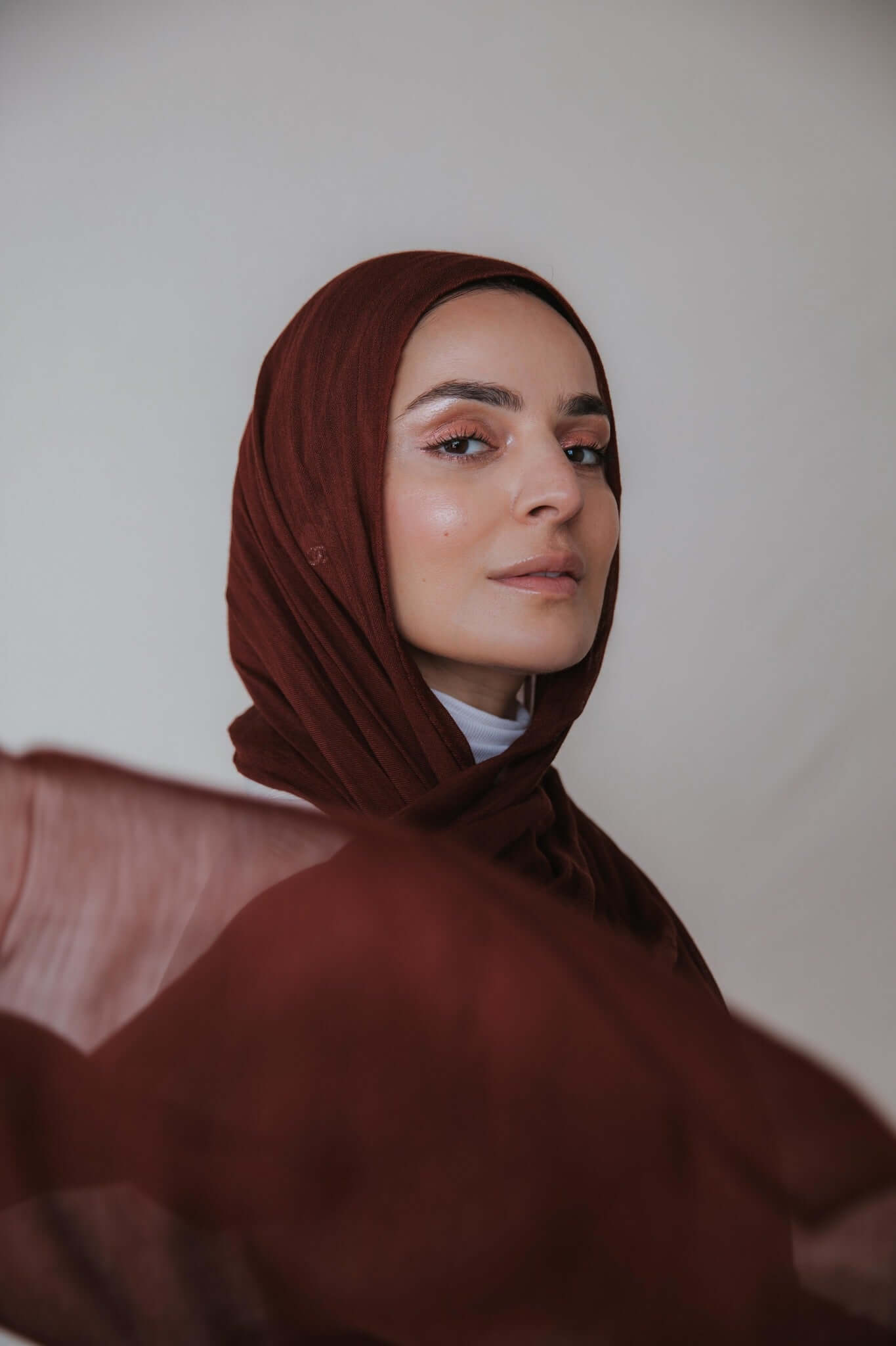 Model wearing soft, airy hijab made from 100% modal with gentle movement and artisanal dyeing.