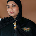 Lightweight celestial hijab with lunar detailing and soft woven texture.