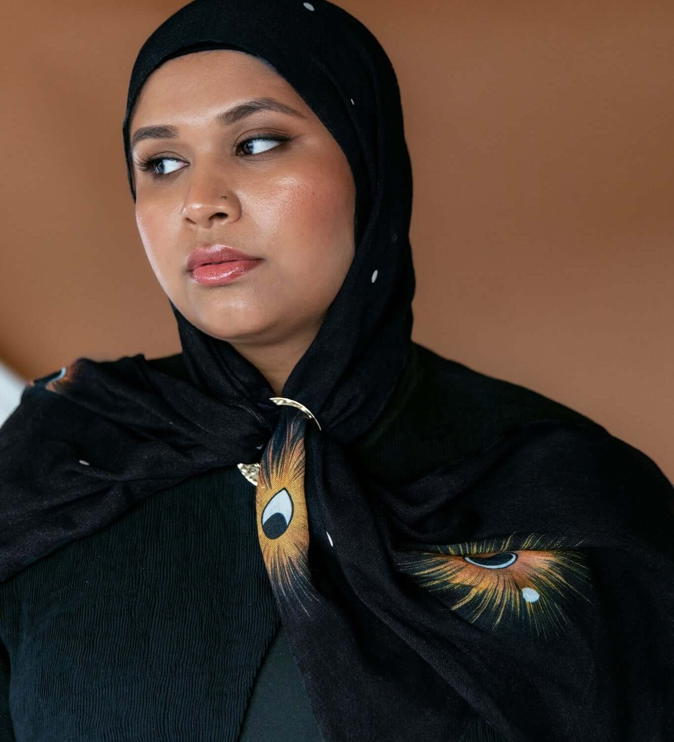 Lightweight celestial hijab with lunar detailing and soft woven texture.