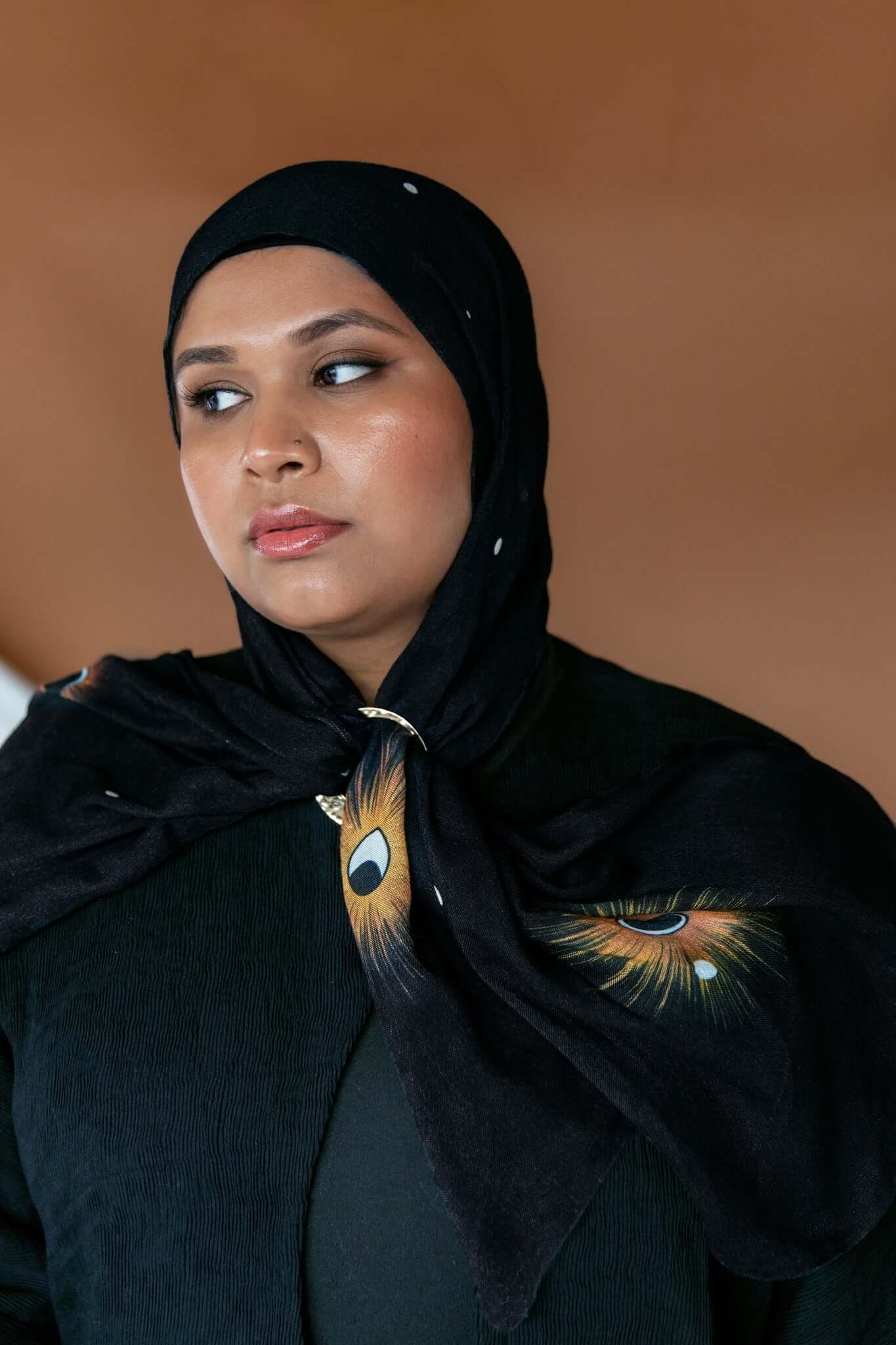 Lightweight celestial hijab with lunar detailing and soft woven texture.