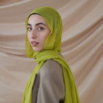 Model wearing VELA bamboo hijab with soft movement and a vibrant, standout tone.