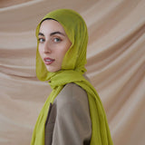 Model wearing VELA bamboo hijab with soft movement and a vibrant, standout tone.
