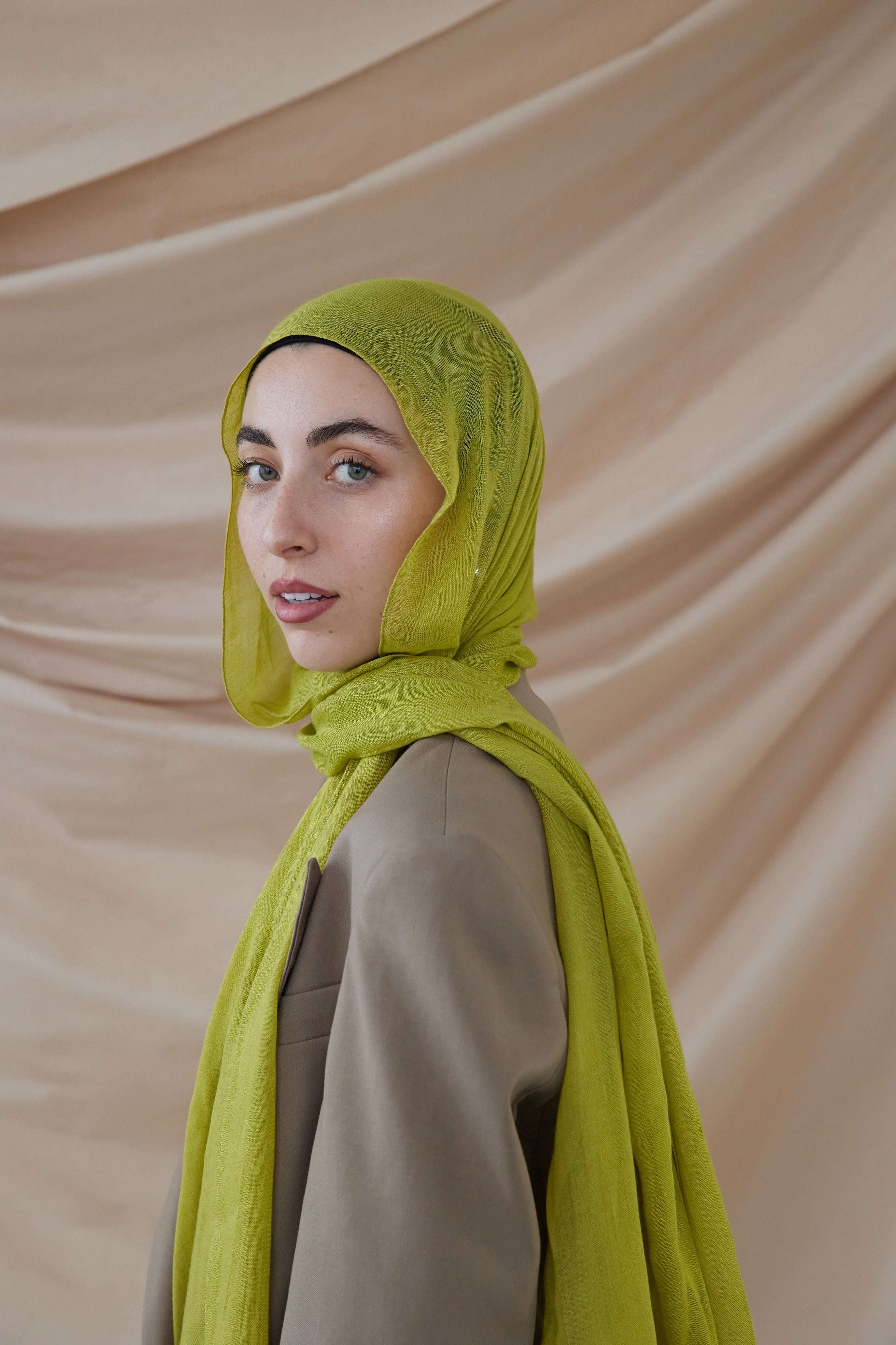 Model wearing VELA bamboo hijab with soft movement and a vibrant, standout tone.