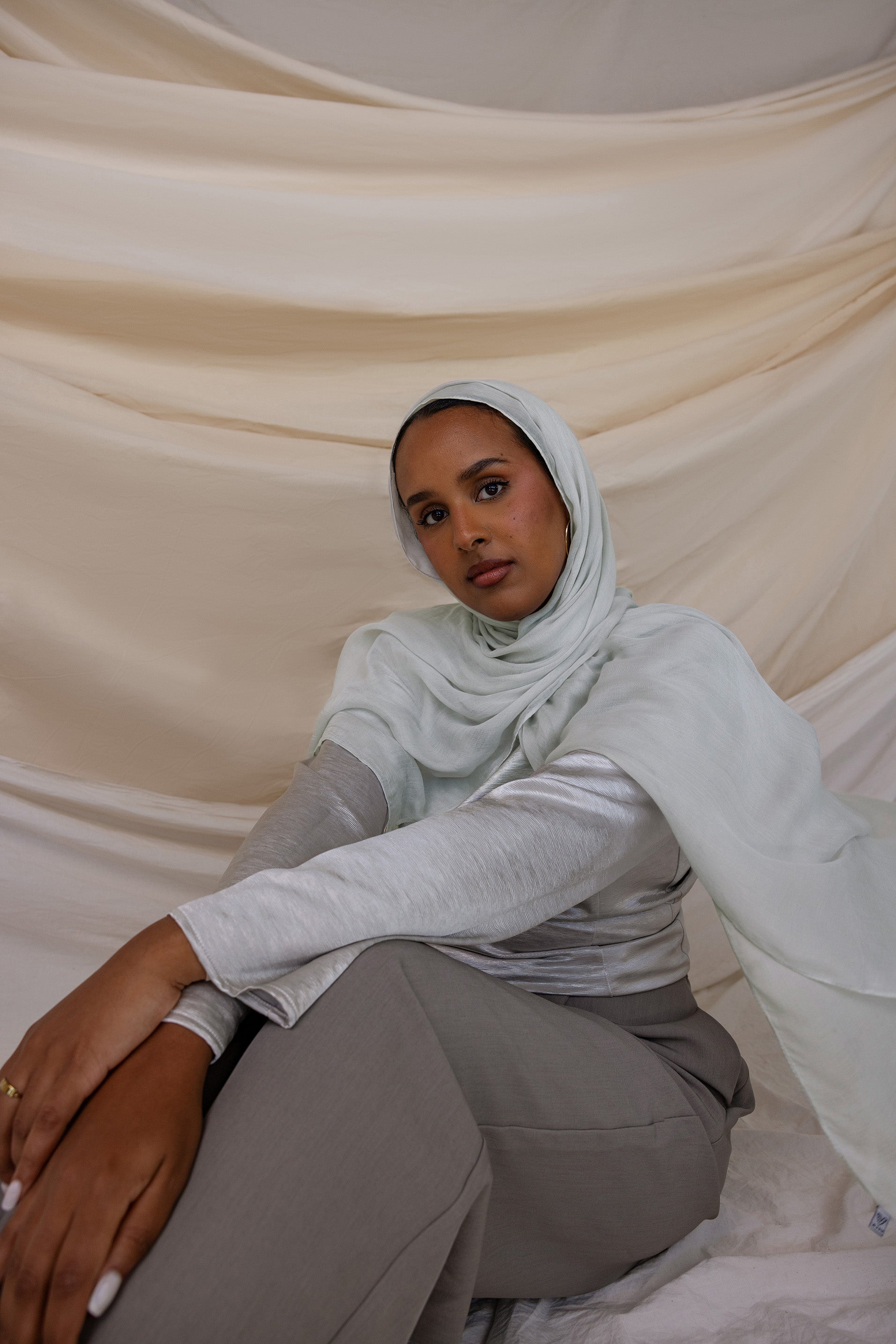 A woman wearing a silver modal hijab
