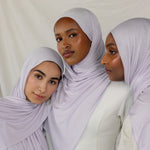 Three models wearing Soft Amethyst Jersey Lite, capturing its soft purple tone from different angles.