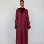 A modern revival of tradition abaya with stitched detail on the back and a breathable finish