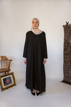 Black full-length underdress with a smooth finish, perfect for layering or wearing solo