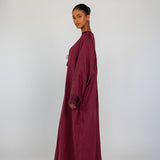 Abaya designed with heritage embroidery along the back and a soft, open-front style