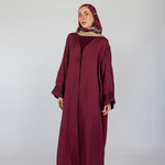 Embroidered abaya with traditional details and a modest silhouette in a soft linen blend