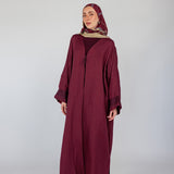 Embroidered abaya with traditional details and a modest silhouette in a soft linen blend