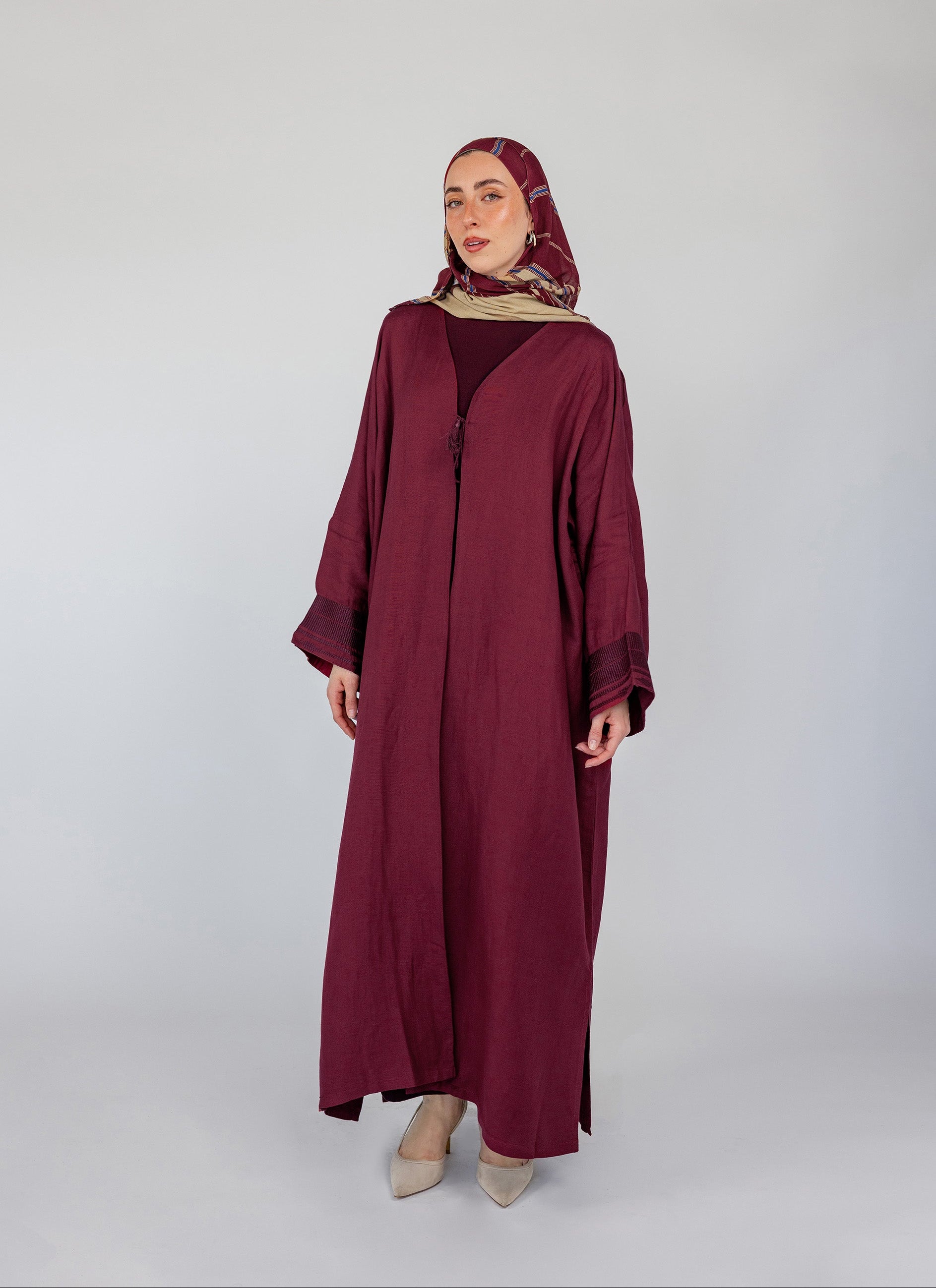 Embroidered abaya with traditional details and a modest silhouette in a soft linen blend
