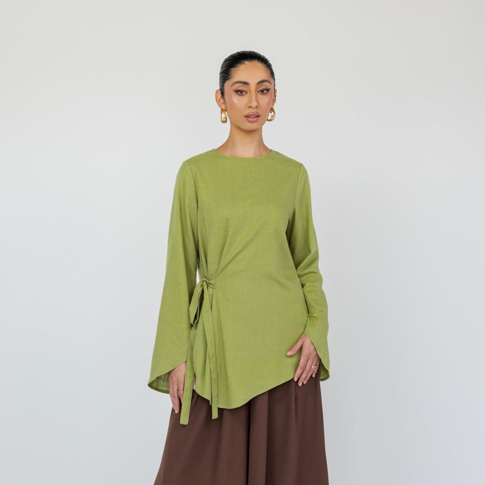 Lightweight long-sleeve top with a relaxed fit and soft front tie detail.