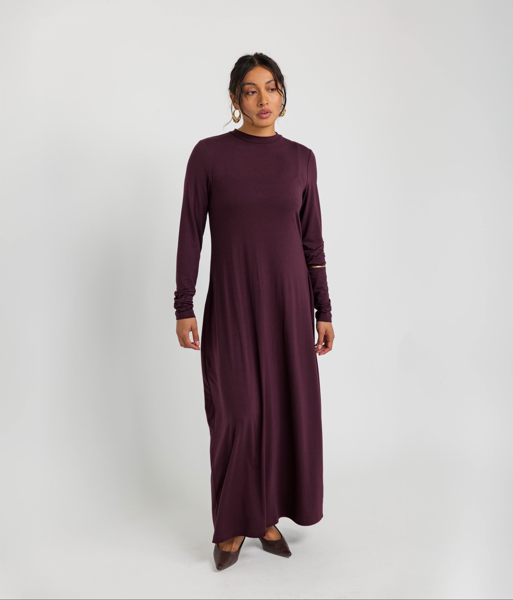 Soft knit under dress designed for layering, with a smooth and flexible fit.