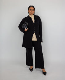 High-waisted flare pants with checkered knit texture and ankle-length finish.