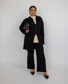 High-waisted flare pants with checkered knit texture and ankle-length finish.