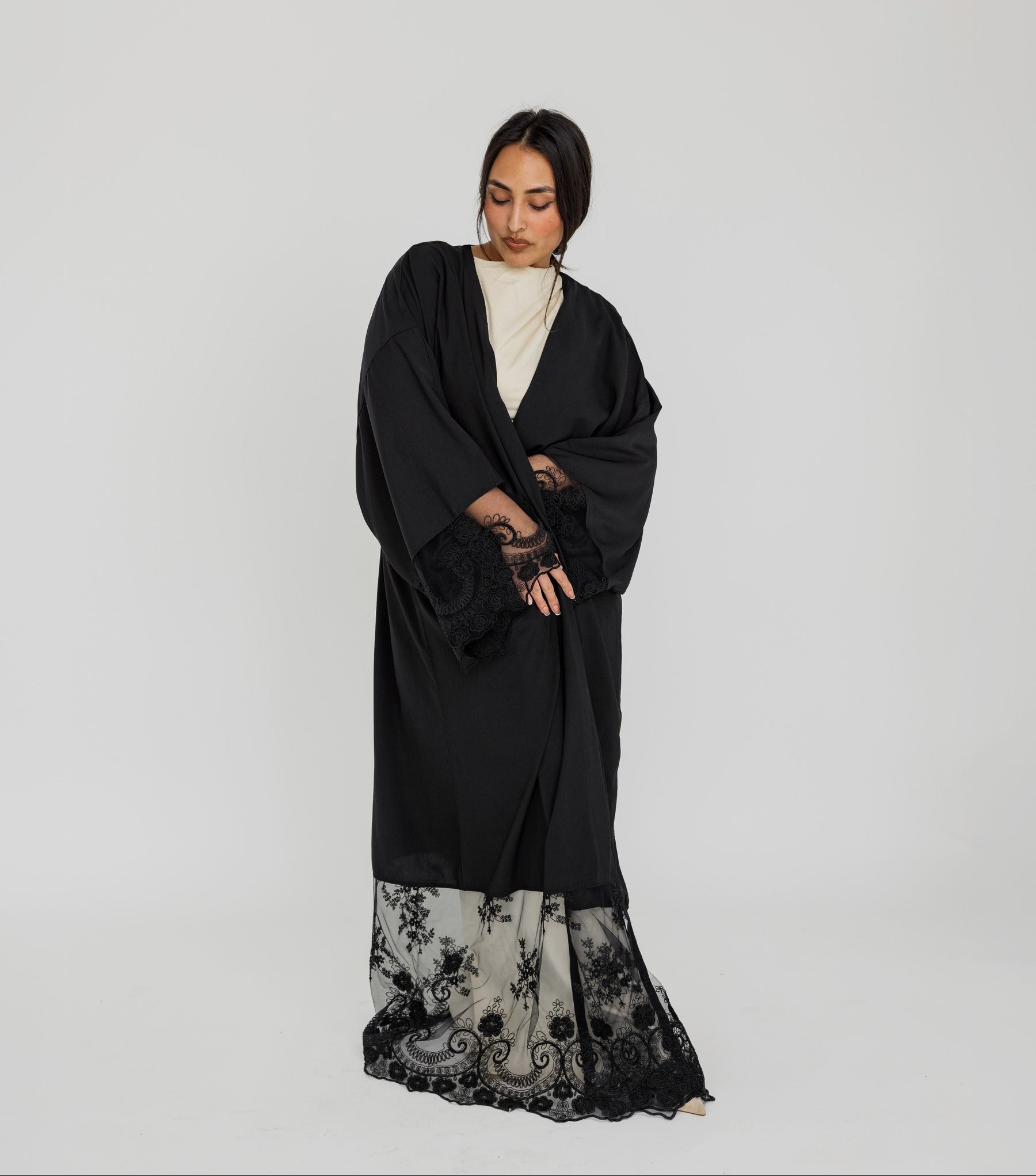 Lace-trimmed abaya with flowing fabric and delicate detailing for a refined finish.