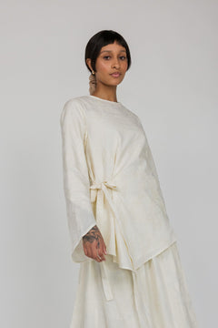 VELA textured cream top featuring a front tie and light, flowy fabric