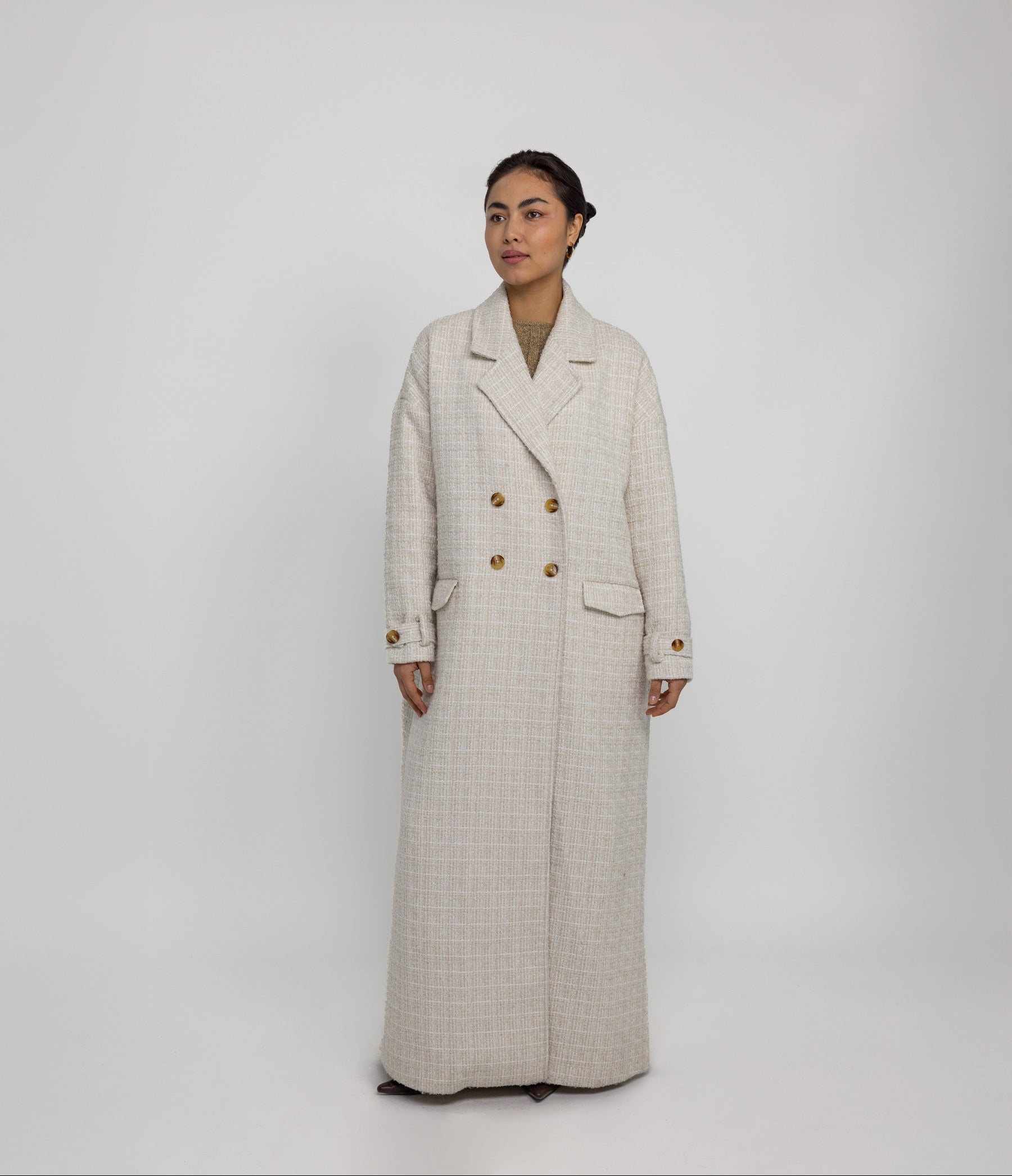 Oversized trench-style abaya coat with tailored details and fluid structure