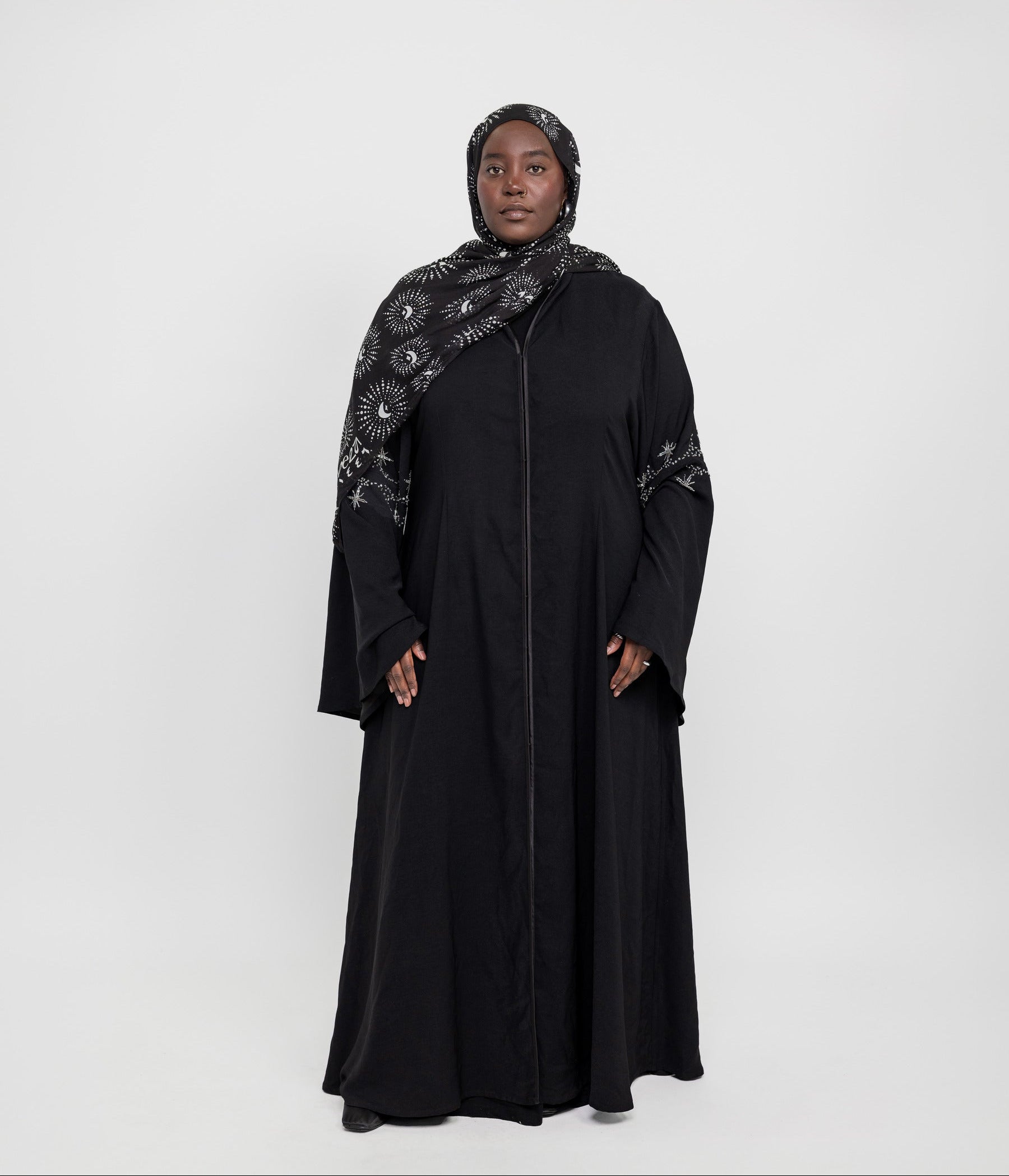 Statement abaya featuring delicate sparkle and flowing flared sleeves