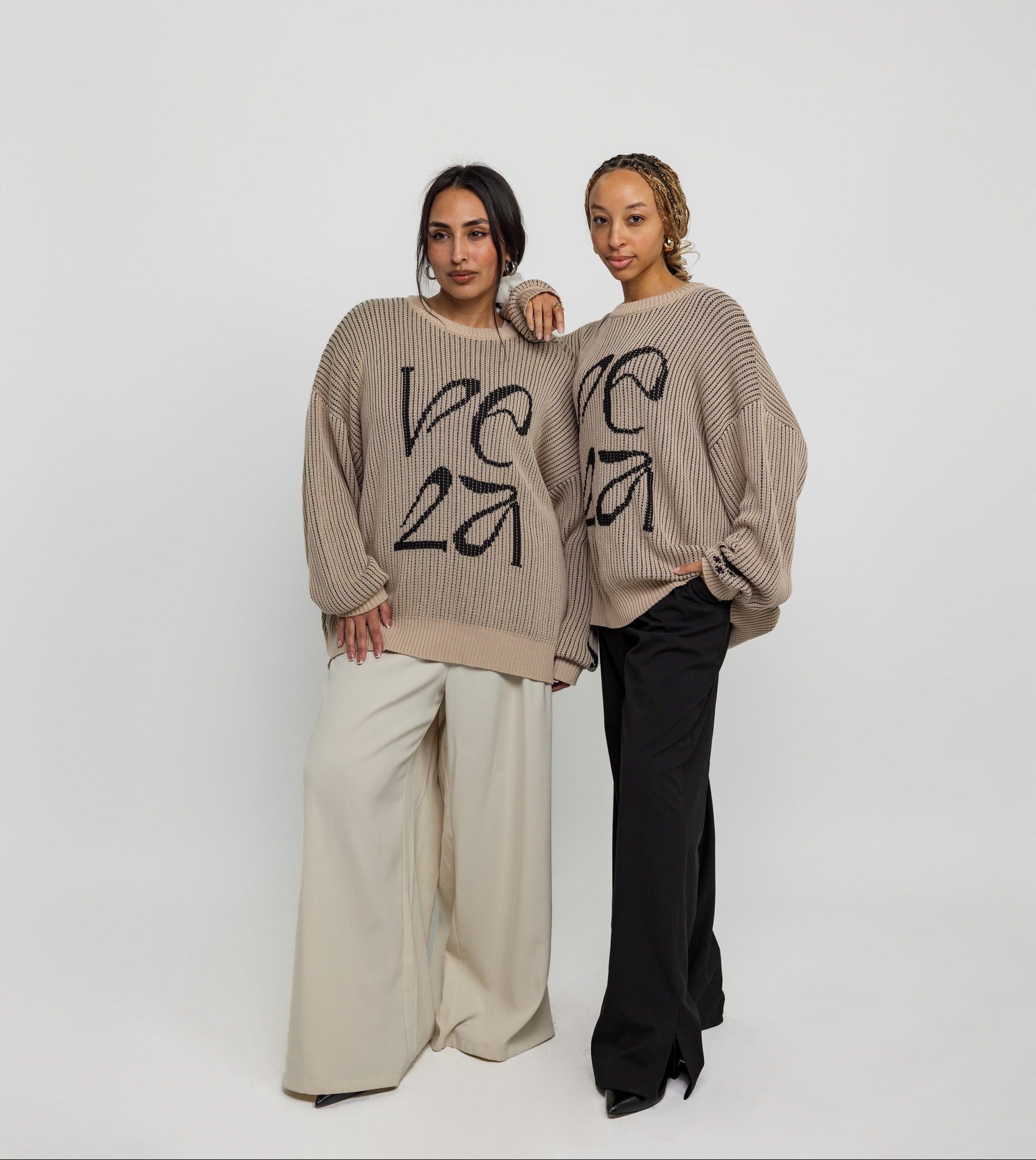 Oversized sweater with arabesque-inspired knit design and subtle stitched logo detail.
