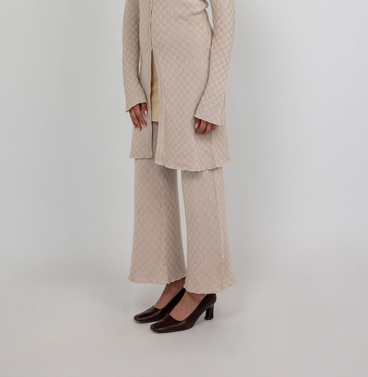 Comfort-fit flared pants with breathable stretch knit and a sleek, ankle-length cut.