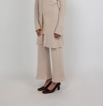 Comfort-fit flared pants with breathable stretch knit and a sleek, ankle-length cut.