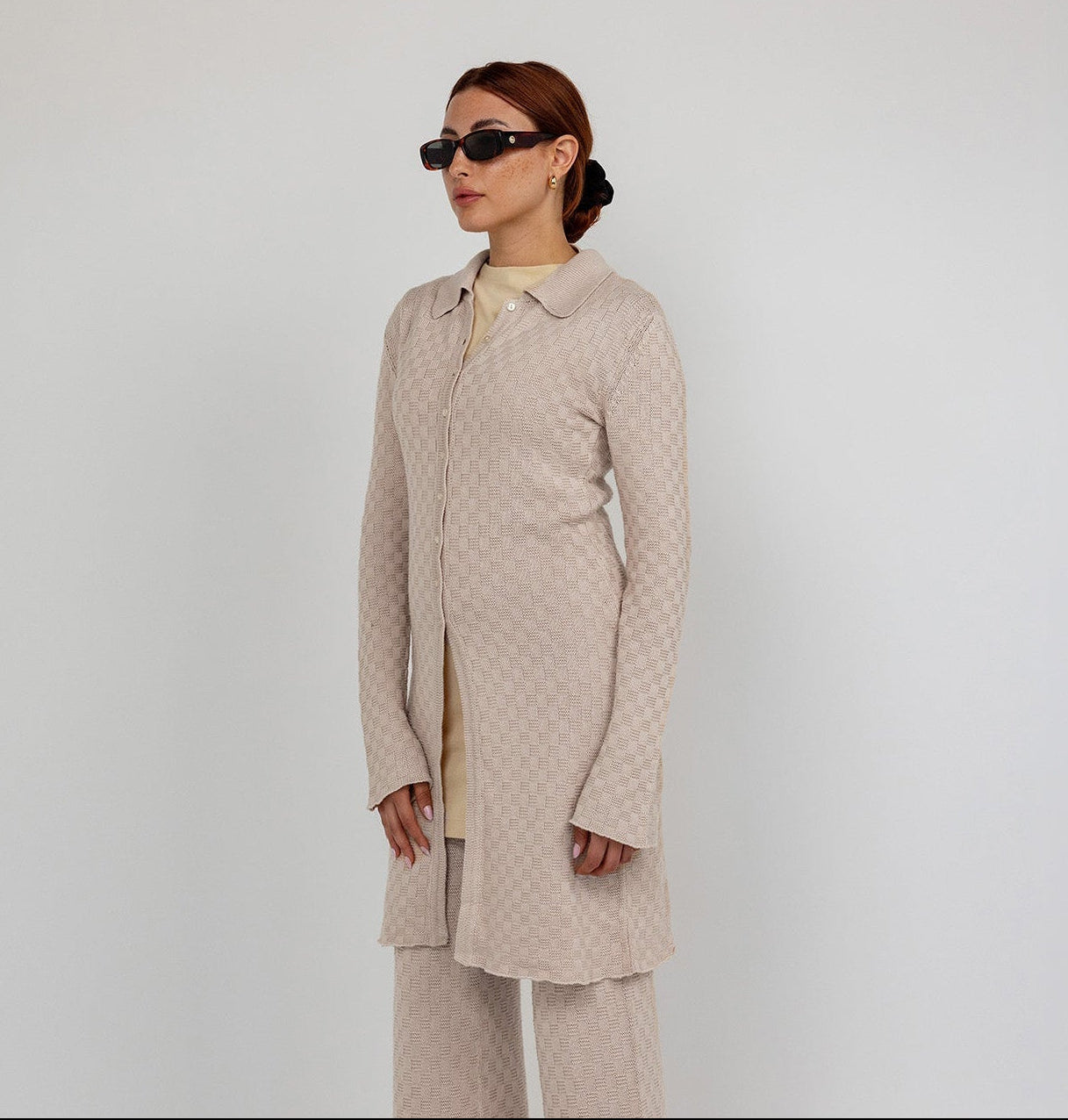 Longline checkered knit cardigan with a tailored fit and soft, breathable fabric.