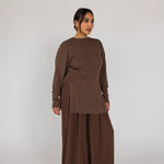 Woman wearing a brown outfit on a white background