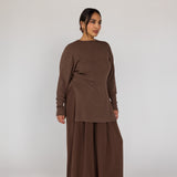Woman wearing a brown outfit on a white background