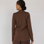 Woman wearing a brown outfit against a white background