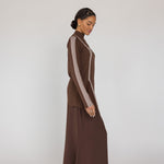 Woman wearing a brown outfit with a white background