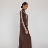 Woman wearing a brown outfit with a white background