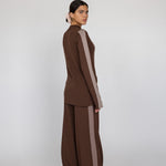 Woman wearing a brown outfit with a white background