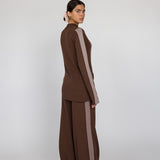 Woman wearing a brown outfit with a white background