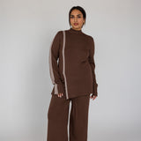 Woman wearing a brown outfit with a white background